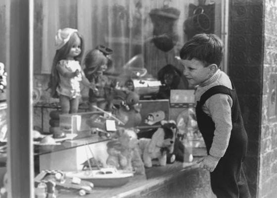 Boy looking in toy shop window