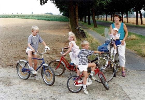 Family on bikes by field