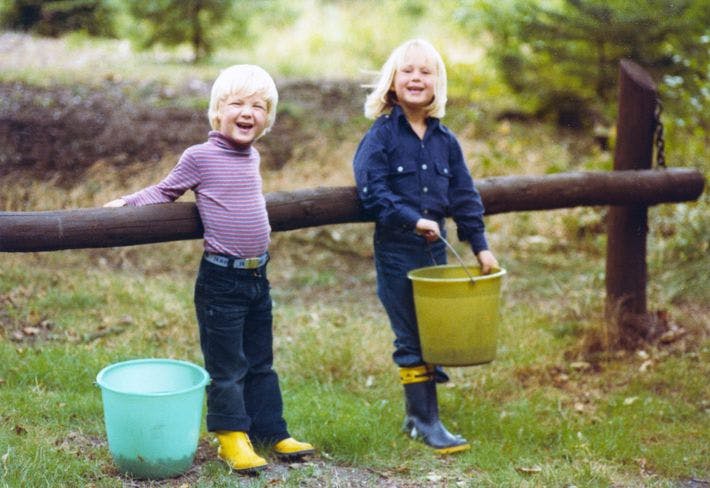 Children smiling holding buckets
