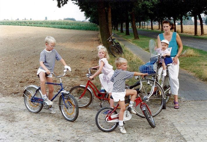 Family on bikes by field