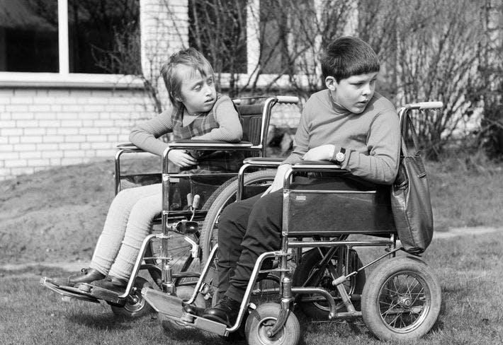 Black and white image of children in wheelchairs